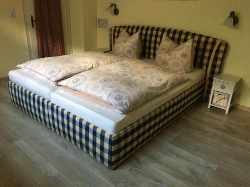 a bed in a bedroom with a blue and white at CASA Palatina in Merzalben