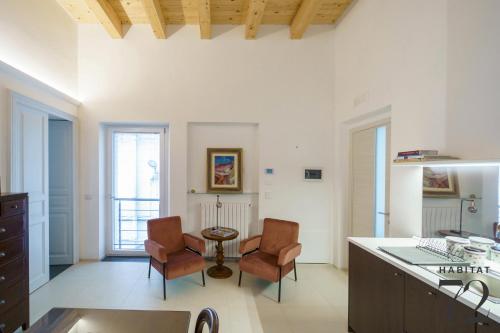 a kitchen with two chairs and a table in a room at Habitat 72 in Enna