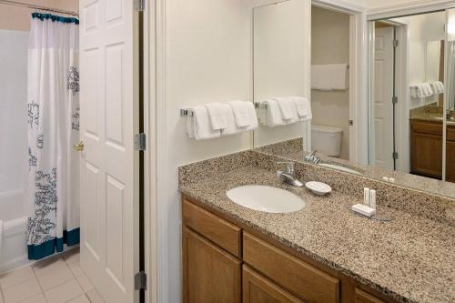 a bathroom with a sink and a mirror at Residence Inn Dallas DFW Airport North/Irving in Irving