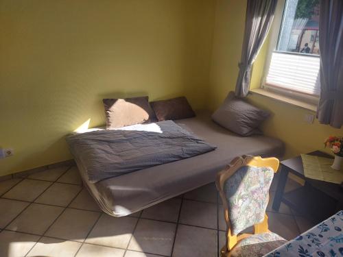 - un lit dans une chambre avec fenêtre dans l'établissement Monteur- & Ferienwohnung Wohnbach 2, à Wölfersheim