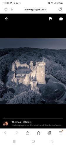 a page of a website with a picture of a castle at Petit maison villageoise in Moulineaux
