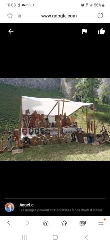 a webpage with a white tent with horses under it at Petit maison villageoise in Moulineaux
