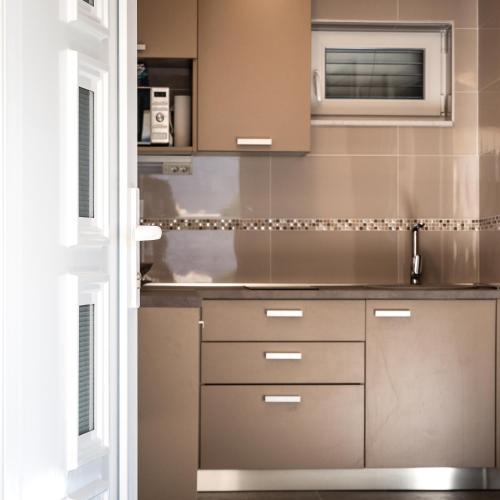 a kitchen with stainless steel cabinets and a microwave at Apartments Delic in Ražanac