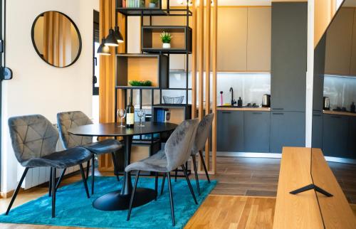 a kitchen and dining room with a table and chairs at LuMi Kolasin in Kolašin