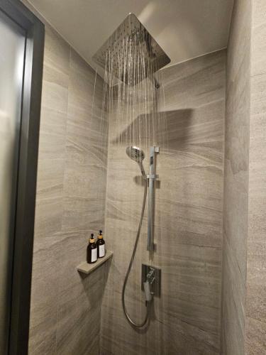 a shower with a shower head in a bathroom at Edge Central Pattaya #187 in Pattaya Central
