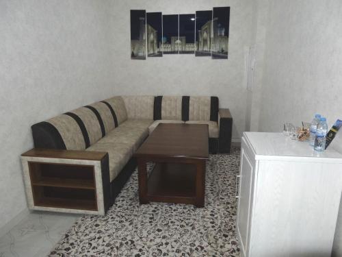 a living room with a couch and a coffee table at OydinPlaza Hotel in Namangan