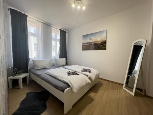 a bedroom with a bed and a mirror in it at Ferienwohnung Just Home in Wismar