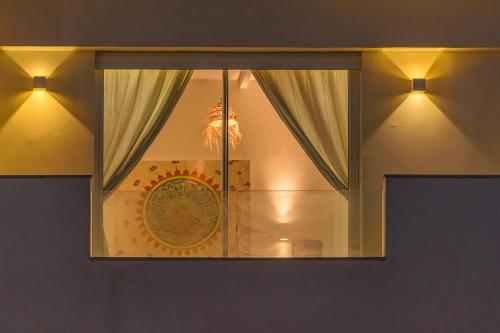 a window in a room with curtains and a clock at Kite House Dakhla in Dakhla