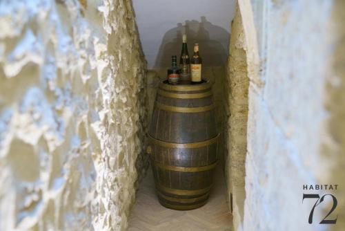 a barrel with bottles of wine in a wall at Habitat 72 in Enna