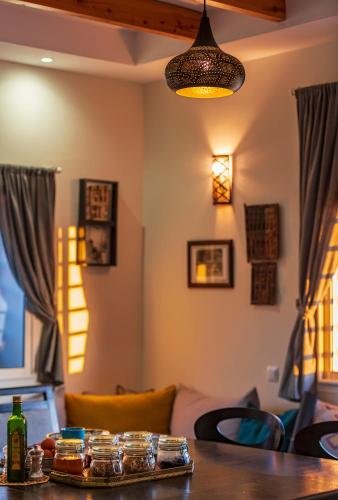 a living room with a table and a lamp at Kite House Dakhla in Dakhla