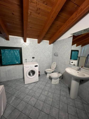 ein Badezimmer mit einer Waschmaschine und einem Waschbecken in der Unterkunft Affittacamere Karma in Rho