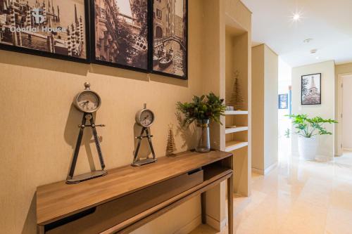a room with a table with two clocks on it at Park view Avalon Apartment District 1 HCM City in Ho Chi Minh City