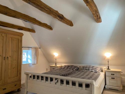 a bedroom with a bed and two night stands at Cottage - Artland's Home - Landhaus für Familien und Gruppen in Badbergen