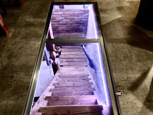 a glass case with stairs in a room at Penzion Za radnicí in Valtice
