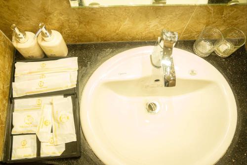 a sink in a bathroom with wine glasses on a counter at TRA LINH HOTEL & RESTAURANTs in Hữu Lũng