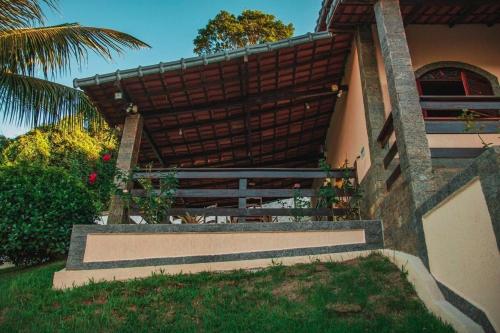 a building with a staircase leading up to a house at Chácara Alegria - Um pedaço do paraíso em Itaboraí in Itaboraí