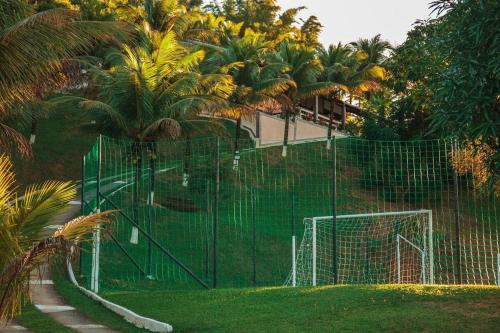 a green fence with a soccer goal in a park at Chácara Alegria - Um pedaço do paraíso em Itaboraí in Itaboraí