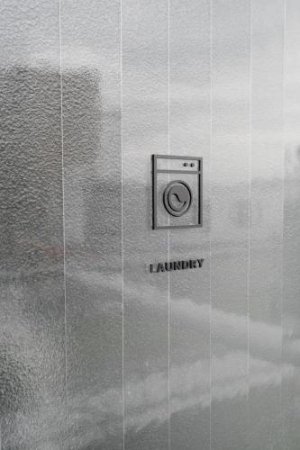 a camera on a wall with the words i laundry at SHIN kyoto in Kyoto