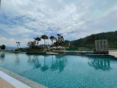 a large swimming pool with a sign in front of it at Liberty ARC - Greenary & Warmest (Wifi) (2-3pax) in Ampang