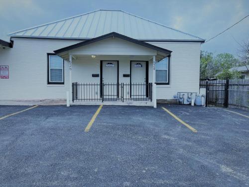 a white building with two doors in a parking lot at Fascinating 2BR1BA Near Festive DT and Riverwalk in San Antonio