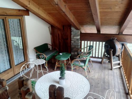a room with a table and chairs and a stove at Hotel Lo Campagnar in Courmayeur