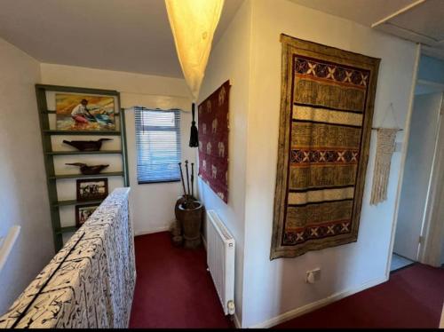 a bedroom with a bed and a wall with a window at Cosy private accommodation in Corsham, near Bath in Corsham