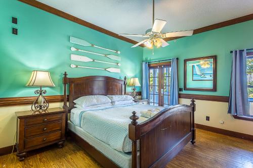 a bedroom with a bed and a ceiling fan at St George Inn in St. George Island