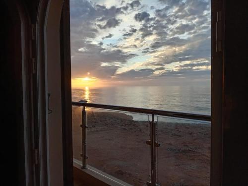 a view of the ocean from a room with a window at Dar diafa samira in Mirleft