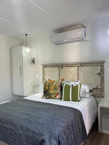 a bedroom with a large bed with pillows on it at INBLOEM in Bloemfontein