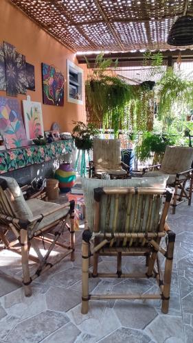 a patio with two chairs and a table at Recanto Toca das Plantas de Ilhabela I in Ilhabela
