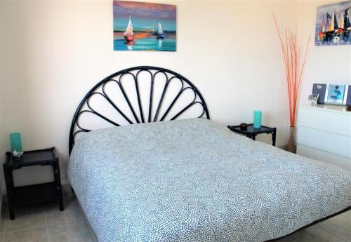 a bedroom with a bed and two end tables at Casa Serendipity Sabaudia in Sabaudia