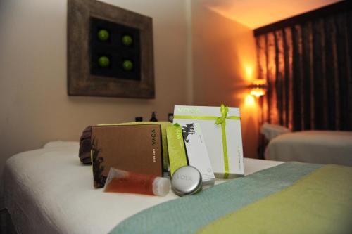a bed with boxes and a clock on it at The Twelve Hotel in Barna