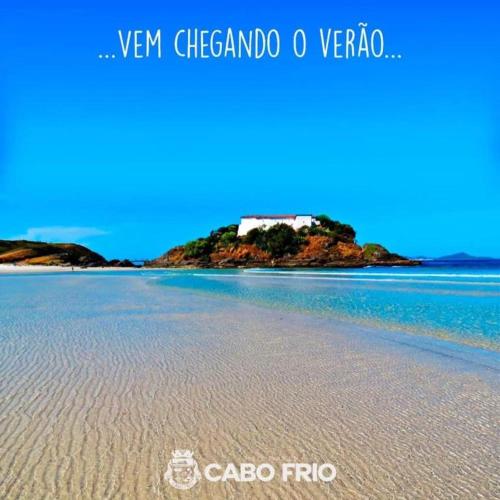 a view of a beach with a house on an island at Meu Aconchego in Cabo Frio