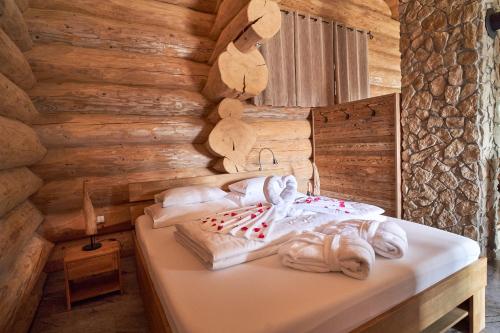 a bedroom with a bed in a wooden wall at Blockhausen Luxus Chalets in Oberschwarzenberg