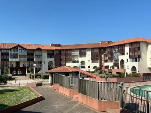 a large apartment building with a pool in front of it at Appartement HOSSEGOR plage SUD Classé 3 étoiles in Soorts-Hossegor