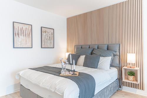 a bedroom with a large bed with a wooden headboard at Apartment Wesseling in Wesseling