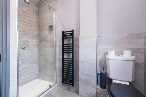 a bathroom with a shower and a toilet and a shower at Impressive Apartment in Derby in Derby