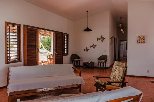 a living room with a bed and a chair at Vila Tao in Fortim