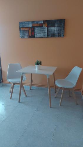 Apartamento Cefas في أو بيدروزو: طاولة وكرسيين في غرفة