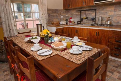 a wooden table in a kitchen with a tableablish at CASA HOSPEDAJE EL LABRADOR in Cusco