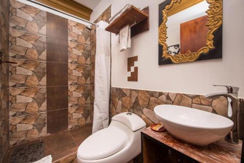 a bathroom with a toilet and a sink and a shower at CASA HOSPEDAJE EL LABRADOR in Cusco
