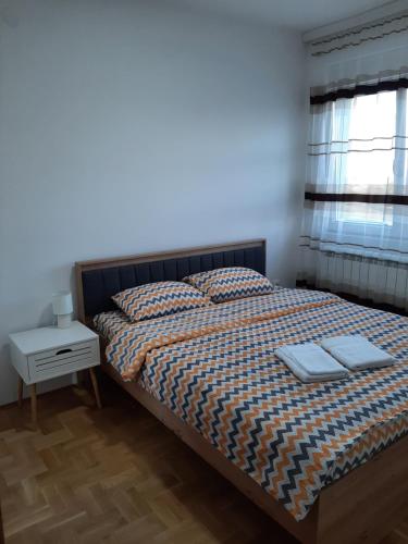 Postel nebo postele na pokoji v ubytování Apartman Milic Pirot-Zapadni Kej 10