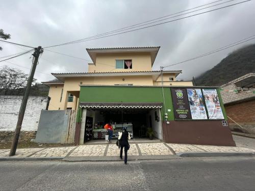 a woman walking down the street in front of a store at Cuarto Ojo de Agua in Orizaba