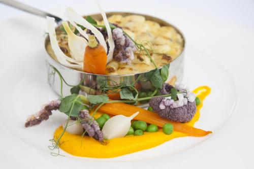 a container filled with vegetables on a white plate at Bromley Court Hotel London in Bromley