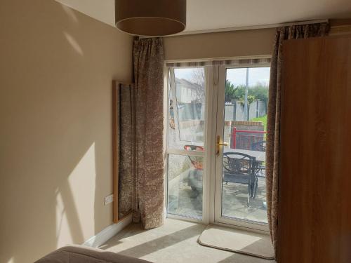 a room with a sliding glass door to a patio at Kilkenny City Apartment in Kilkenny