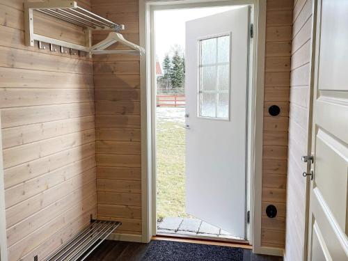 a sauna with wood paneling and a door at Holiday home GRIMSTORP in Grimstorp