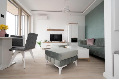 a living room with a couch and a table at Apartman Maja Lux in Subotica
