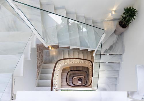 a spiral staircase with a glass stair case at La Casa de las Flores in Cartagena