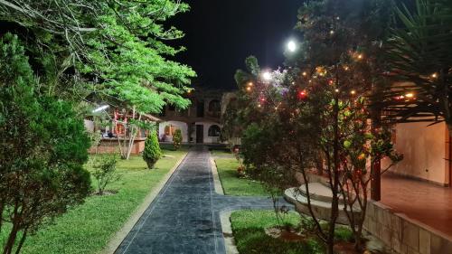 a garden at night with trees and lights at Hospedaje El Cascabel in Sunampe