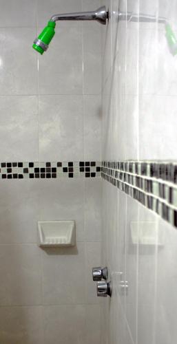 a shower with a green light in a bathroom at Hotel del Refugio in Guadalajara